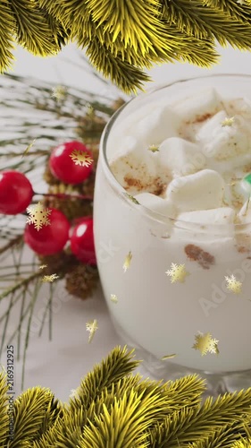 Animation of stars falling over christmas drink and decorations