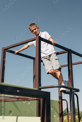 Happy Boy Playing on Modern Playground
