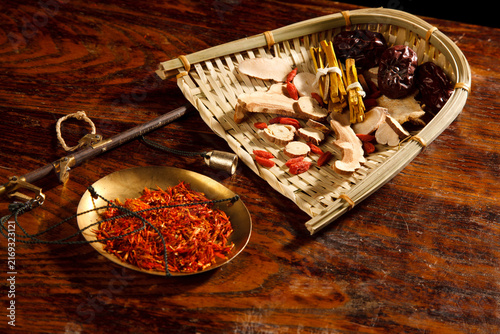 Fotografie Chinese Medicinal Herbs with Paeonia Lactiflora on Wooden Scale
