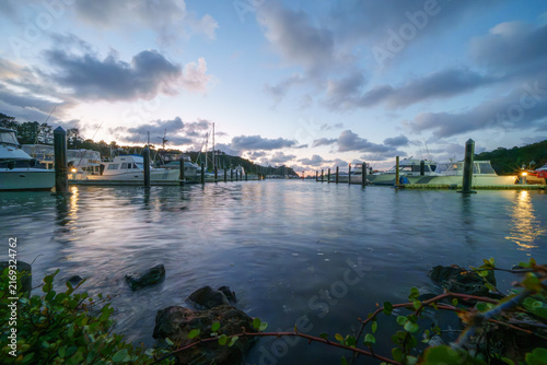 Boats in marina at dawn from waters edge at Tutukaka
