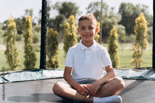 Happy Boy Enjoying Outdoor Trampoline Fun
