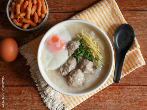 Congee or rice porridge top with minced pork, ginger and green onion. Popular breakfast bowl in China, Thailand, and Asia.