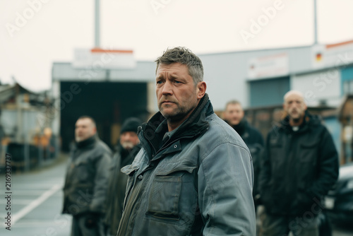 Generative AI - Laid off people standing in front of a closed manufacture, financial crisis