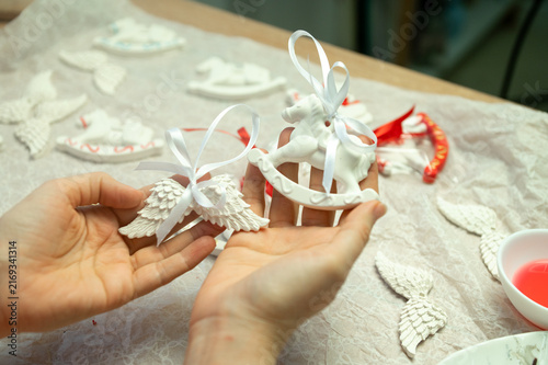 Принти на полотні Crafting decorative white clay ornaments with angel wings and horse designs