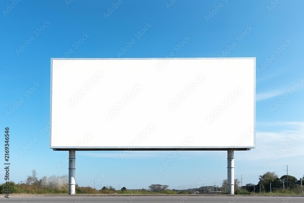 Fototapeta premium Blank billboard presenting a white screen for marketing, branding on a clear blue sky day