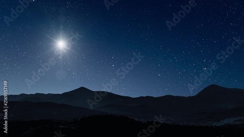 Glowing Christmas star above a peaceful mountain landscape with night sky