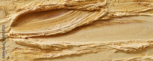 Close Up View of Beige Cosmetic Foundation Texture with Smooth Creamy Swirls