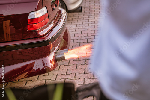 Canvas Print Tuned car exhausting flames with spectator watching