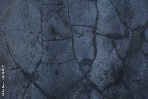 Dark blue cracked concrete texture background with weathered stone surface pattern