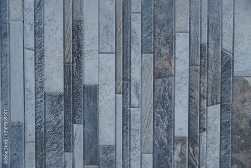 Modern stone wall cladding texture with vertical grey and white granite tiles