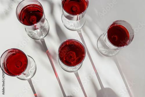 Obraz na płótnie Arrangement of red wine glasses across surface
