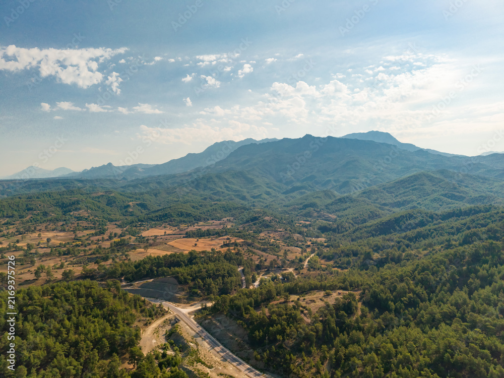 Fototapeta premium Aerial mountain landscape with forest road and rural countryside in Turkey