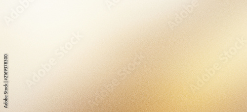 Champagne gold metallic texture with soft light gradient. Elegant brushed metal background for luxury branding. Shimmering golden foil surface.
