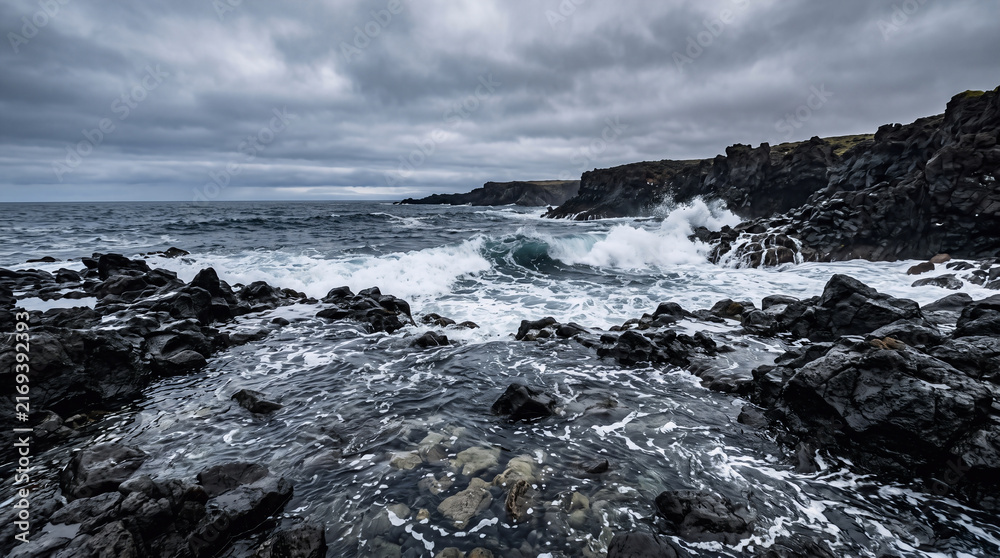 Fototapeta premium Dramatic ultra-realistic ocean landscape viewed from a low angle, dark volcanic rocks protruding through deep blue seawater in the foreground, several stones clearly visible beneath translucent waves