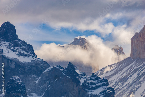 Mountain peaks partly shrouded in fog and clouds, Torres del Paine National Park Chile