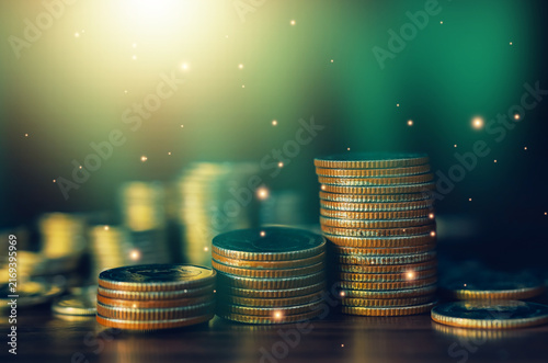 Growing stacks of coins on a dark green background symbolize savings, wealth accumulation, investment growth, financial planning, passive income, and long-term economic success concepts.