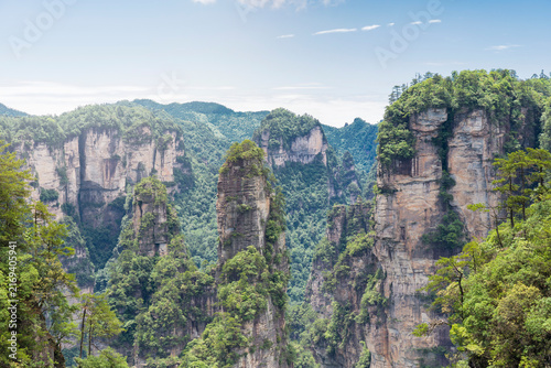 Konstfotografi Majestic landscape with green lush foliage karst mountain pillars and peaks in Z