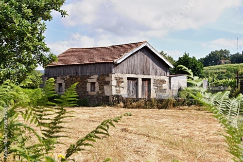 Rustic stone barn in rural summer landscape. Quintadona, Portugal - Norte
