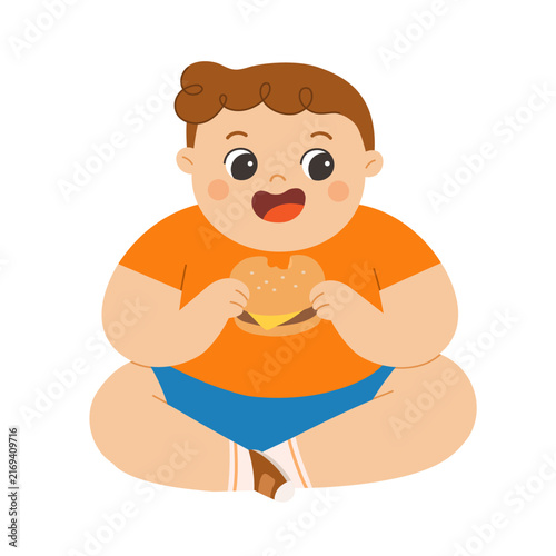 A chubby overweight boy sitting and happily eating a hamburger