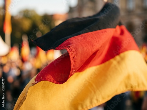 German flag waving in the wind, close up shot of national symbol of Germany outdoors.