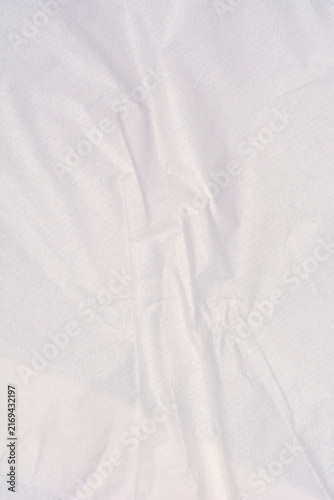 Fotografie Detailed macro view of a thin white packaging paper surface showing soft creases and vertical folds