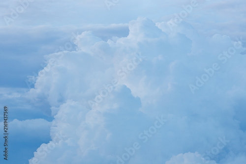 Принти на полотні Dense white cumulus clouds building up against a soft blue atmospheric sky