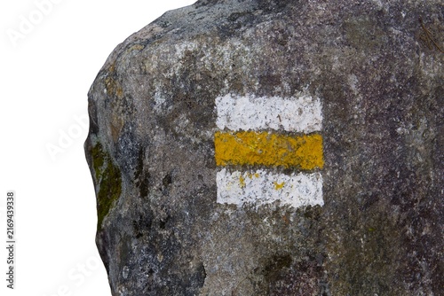 Konstfotografi Rock with a yellow and white painted hiking trail marker isolated on a white bac