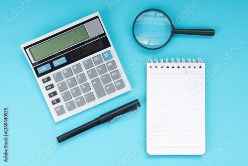 High Angle of Calculator with Pen Notebook and Magnifying Glass for Accounting