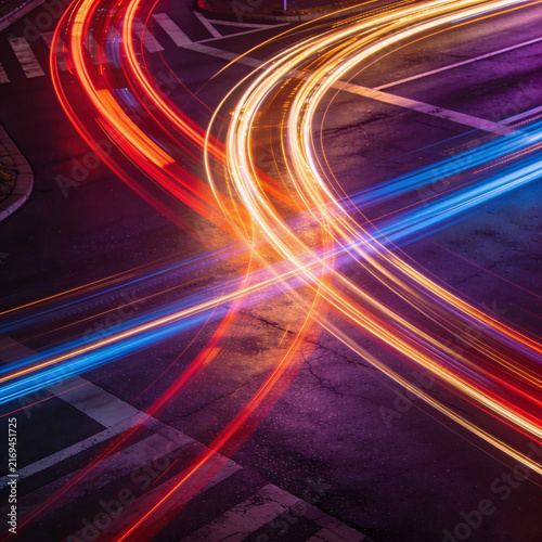 Busy night city intersection long exposure light trails. Modern traffic motion, vehicle lights, highway crossroad. AI generated