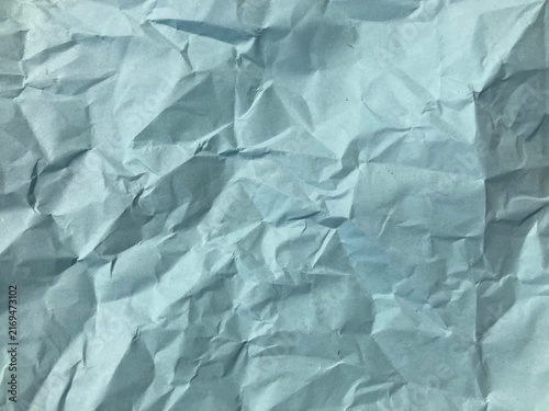 Blue Crumpled Paper Texture, Wrinkled Sheet Surface with Soft Folds and Creases, Light Cyan Paper Background for Craft, Scrapbook, Packaging, Posters and Creative Projects