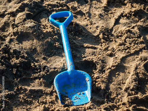 Photography a child's toy shovel forgotten in the sandbox