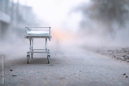 Empty canvas medical stretcher on street covered with debris and dust, melancholic and cinematic mood, realistic disaster zone