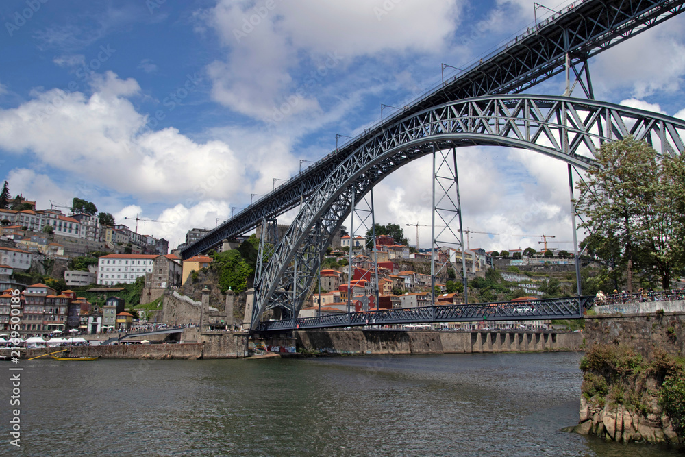 Fototapeta premium View of the historic city of Porto, Portugal with the Dom Luis bridge and blue sky Panoramic view from the city of Porto in Portugal Ancient city Porto,metallic ...