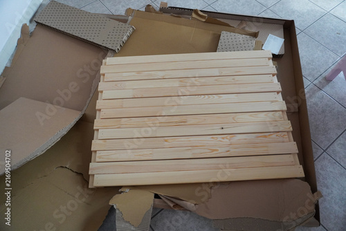 Assembling a children's bed. Furniture parts. New furniture unpacking. Assembling furniture at home. DIY concept with detailed view of furniture installation process.