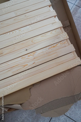 Assembling a children's bed. Furniture parts. New furniture unpacking. Assembling furniture at home. DIY concept with detailed view of furniture installation process.