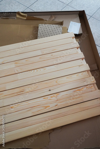 Assembling a children's bed. Furniture parts. New furniture unpacking. Assembling furniture at home. DIY concept with detailed view of furniture installation process.