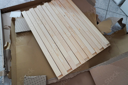 Assembling a children's bed. Furniture parts. New furniture unpacking. Assembling furniture at home. DIY concept with detailed view of furniture installation process.