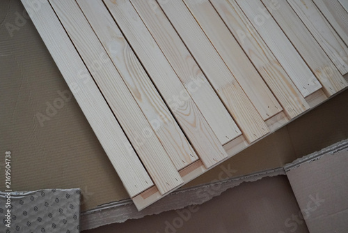 Assembling a children's bed. Furniture parts. New furniture unpacking. Assembling furniture at home. DIY concept with detailed view of furniture installation process.