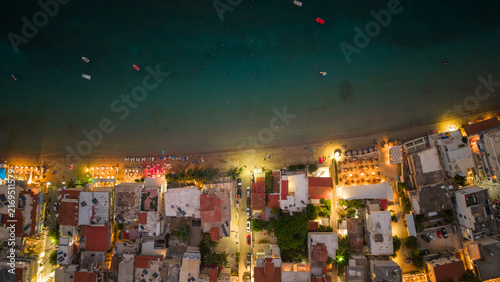Top down aerial view of illuminated coast town