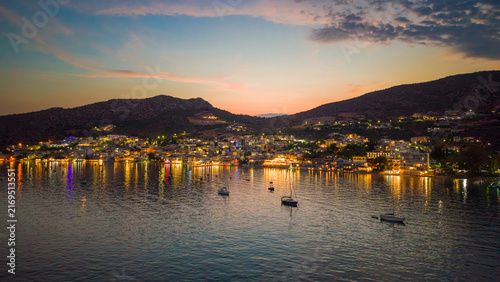 Drone view of the lights of a Greek coastal town at dusk