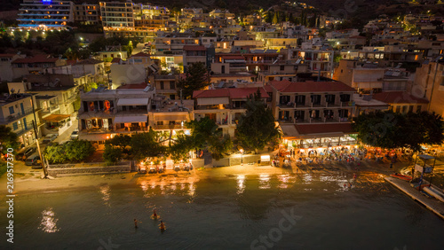 Aerial view of coastal town with restaurants and bars on the beach