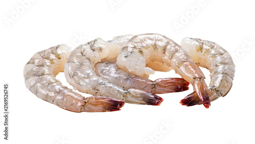 Several raw peeled shrimp arranged in a group, showing translucent flesh and pink tails, isolated on a solid black background surface