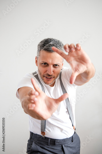 Expressive Mature Man Reaching Toward Camera with Hands