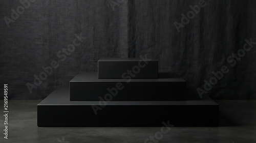 Black tiered pedestal set against textured dark fabric backdrop for luxury product display.