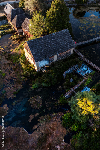 Canvastavla Top down aerial view of old traditional wooden watermills and clear river source at Majerovo Vrilo in Croatia