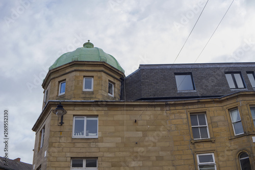 Принти на полотні Historic architecture detail featuring a yellow sandstone building with a weathe