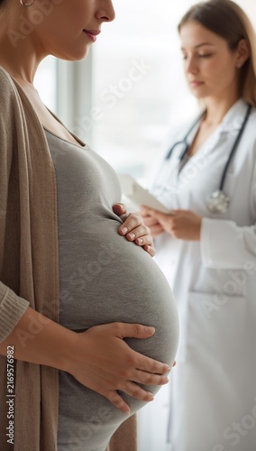 Pregnant woman receiving prenatal care from a female doctor during a routine pregnancy examination.