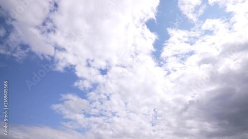 Expanding partly cloudy sky with bright central gap and advancing cumulus bank, with sky, cloud, cumulus, blue detail, showing white, gray, partly, overcast context