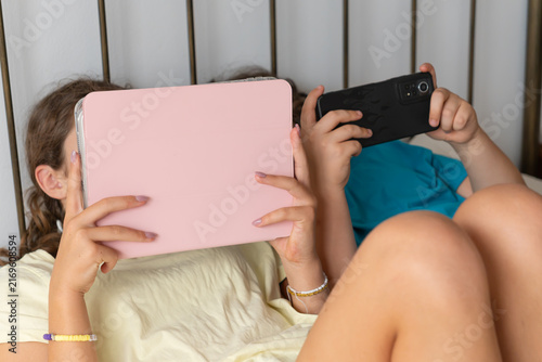 Kids immersed in devices, illustrating digital dependence and screen time addiction among youth