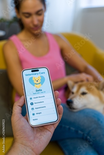 A smartphone displays a veterinary care application as a Hispanic